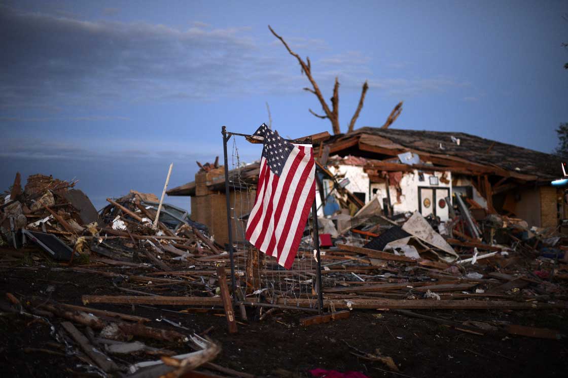 A U.S. flag is seen amongst the debris of a tornado devastated house on May 21, 2013 in Moore, Oklahoma. 