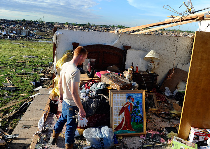 A man salvage stuffs from his grandmother’s tornado devastated home on May 21, 2013 in Moore, Oklahoma. Getty Images
