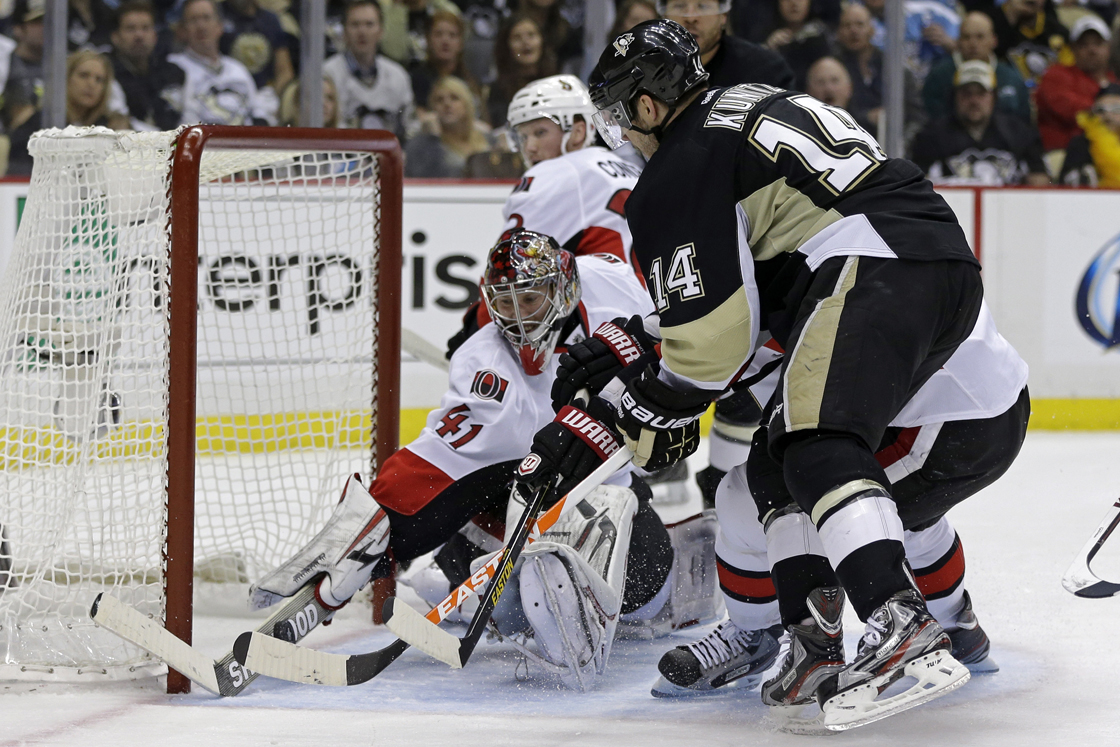 Pittsburgh Penguins' Chris Kunitz (14) gets the puck over the stick of Ottawa Senators goalie Craig Anderson (41) for a goal in the second period of Game 1 of an NHL hockey Stanley Cup second-round playoff series against the Ottawa Senators in Pittsburgh, Tuesday, May 14, 2013. 