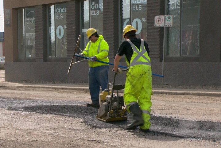 Crews in Saskatoon filling potholes on residential streets in conjunction with street sweeping.