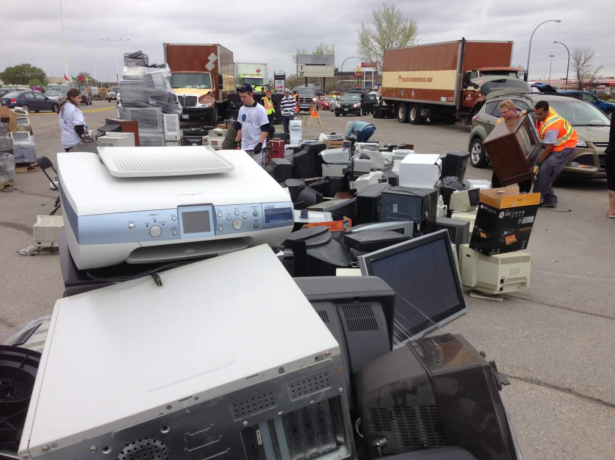 An unwanted computer tower sits atop a stack of old electronics at 'Recyclathon' at Winnipeg's Garden City Shopping Centre parking lot on May 25, 2013.