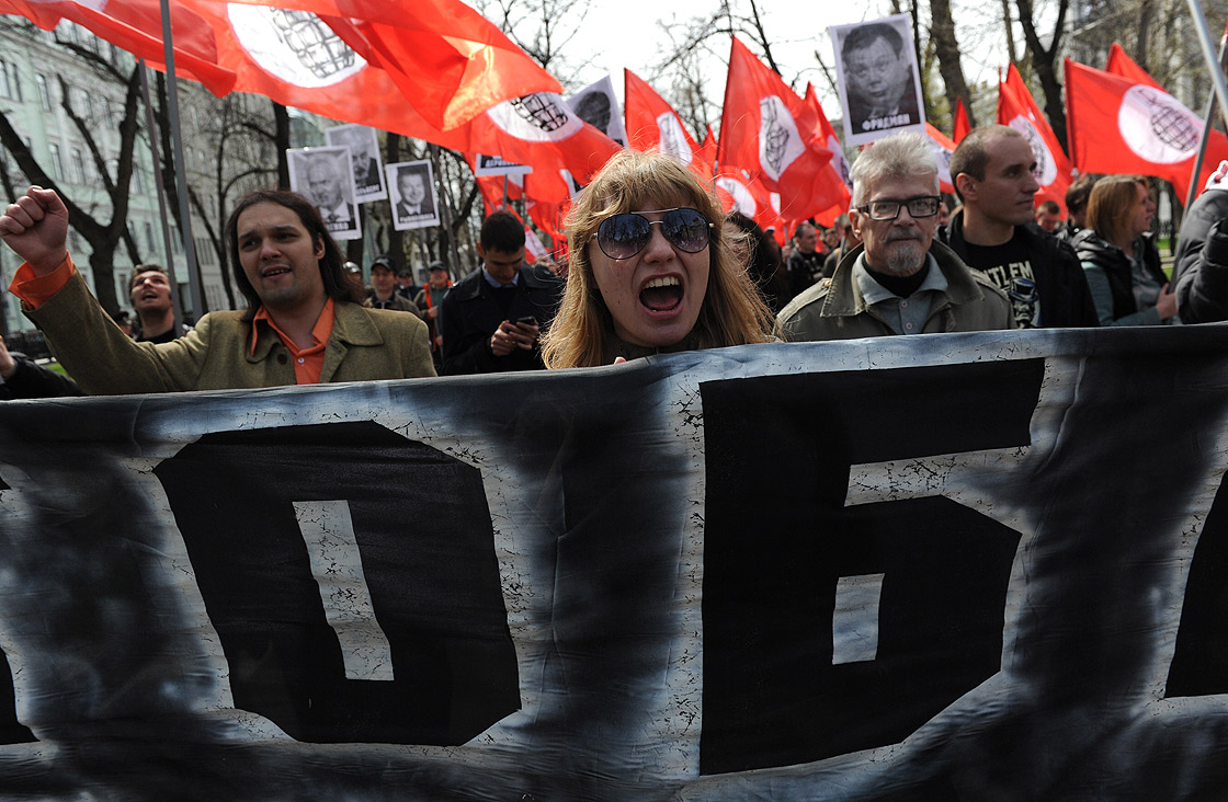 Members of leftist opposition groups take part in their traditional May Day rally in Moscow on May 1, 2013, with leftist leader and writer Eduard Limonov (2nd R) attending. 