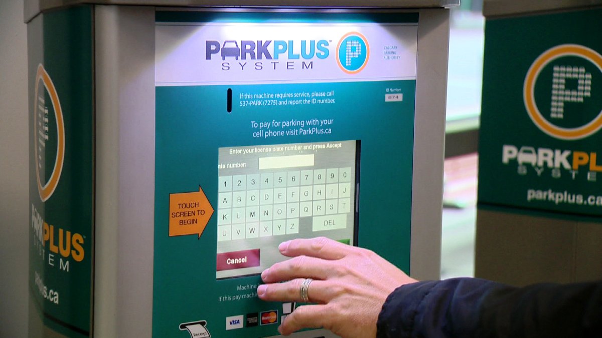 A Calgary driver pays for their parking with a Park Plus machine.