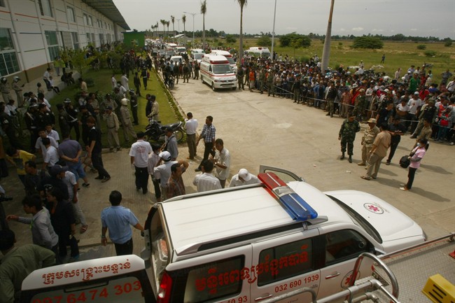 Ambulances park as they wait to transfer injured workers, at the site of a factory collapse in Kai Ruong village, south of Phnom Penh, Cambodia.