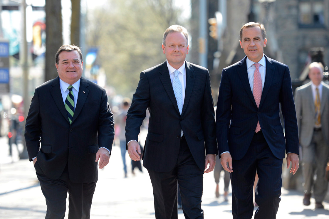Stephen Poloz (centre) walks with Finance Minister Jim Flaherty (left) and Mark Carney after being named as the next Governor of the Bank of Canada during a news conference , Thursday May 2, 2013 in Ottawa. 
