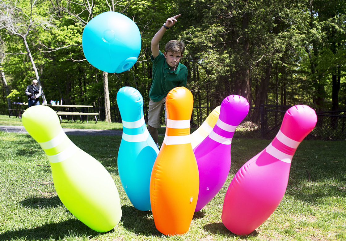 Jeffrey Versluis, 12, plays with an oversized inflatable bowling set at the Canadian Toy Association's 8th annual Hot Toys of Summer event on Wednesday, May 15, 2013 in Toronto. 