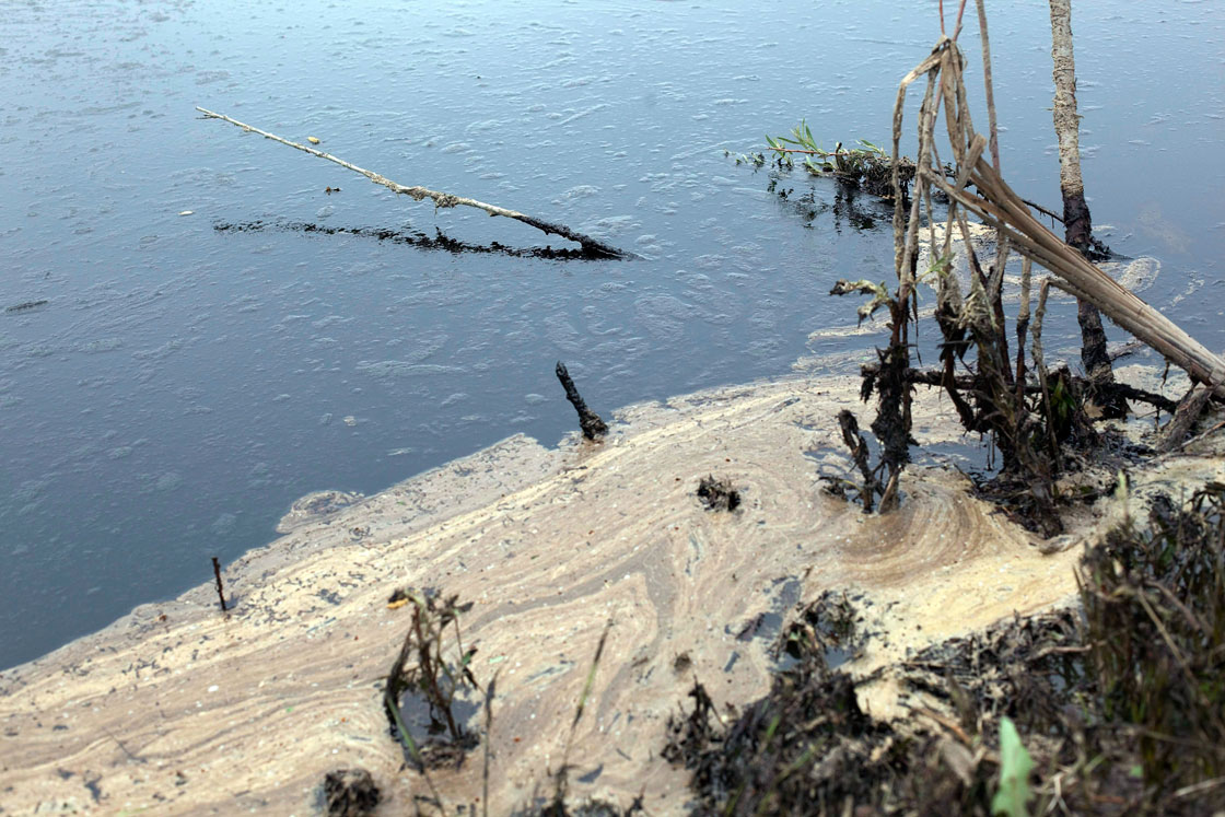 Oil from a pipeline leak coats a pond
