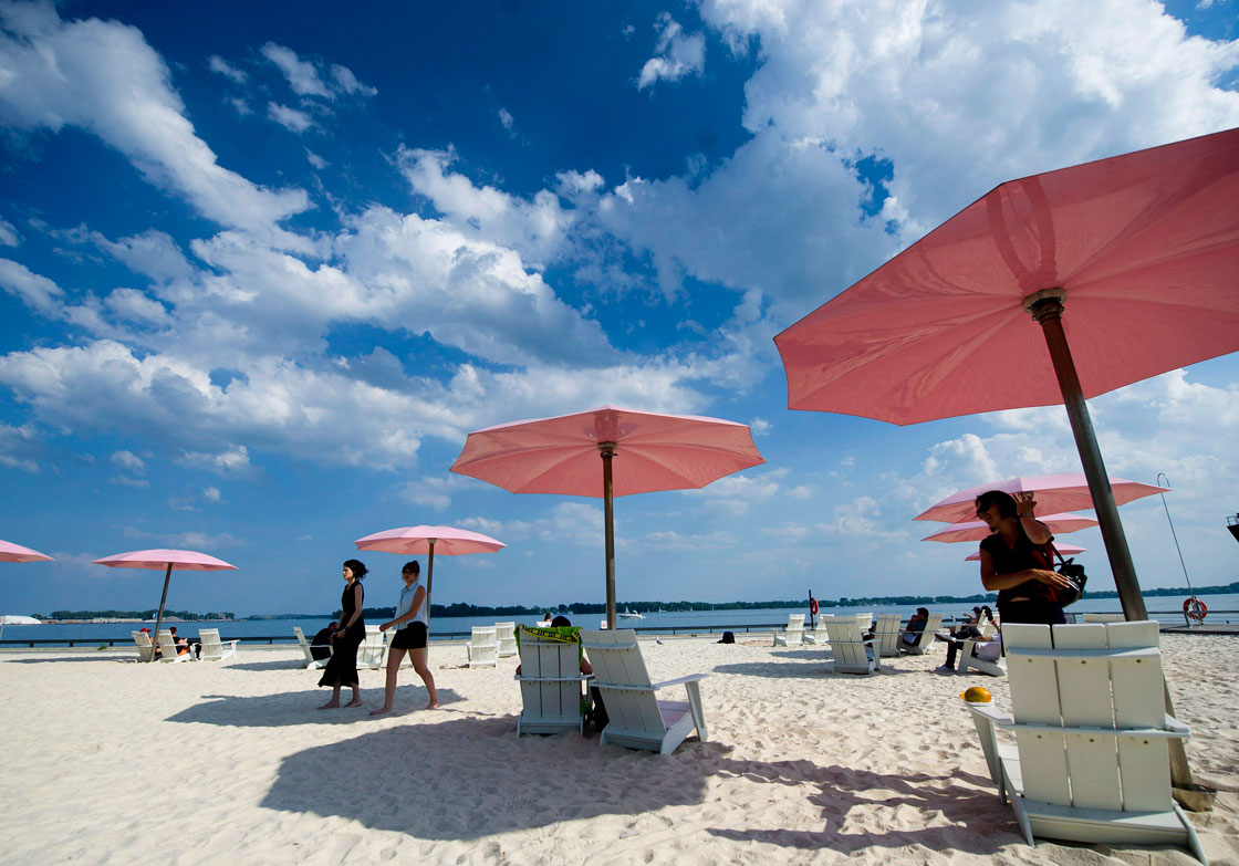 People take in the sun at Sugar Beach in Toronto on Wednesday, July 4, 2012.