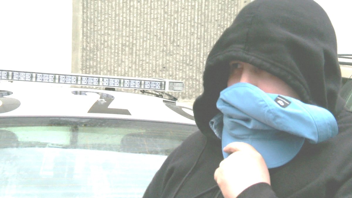 Ryan Bostrom walks to the Calgary Police arrest processing unit in 2013.
