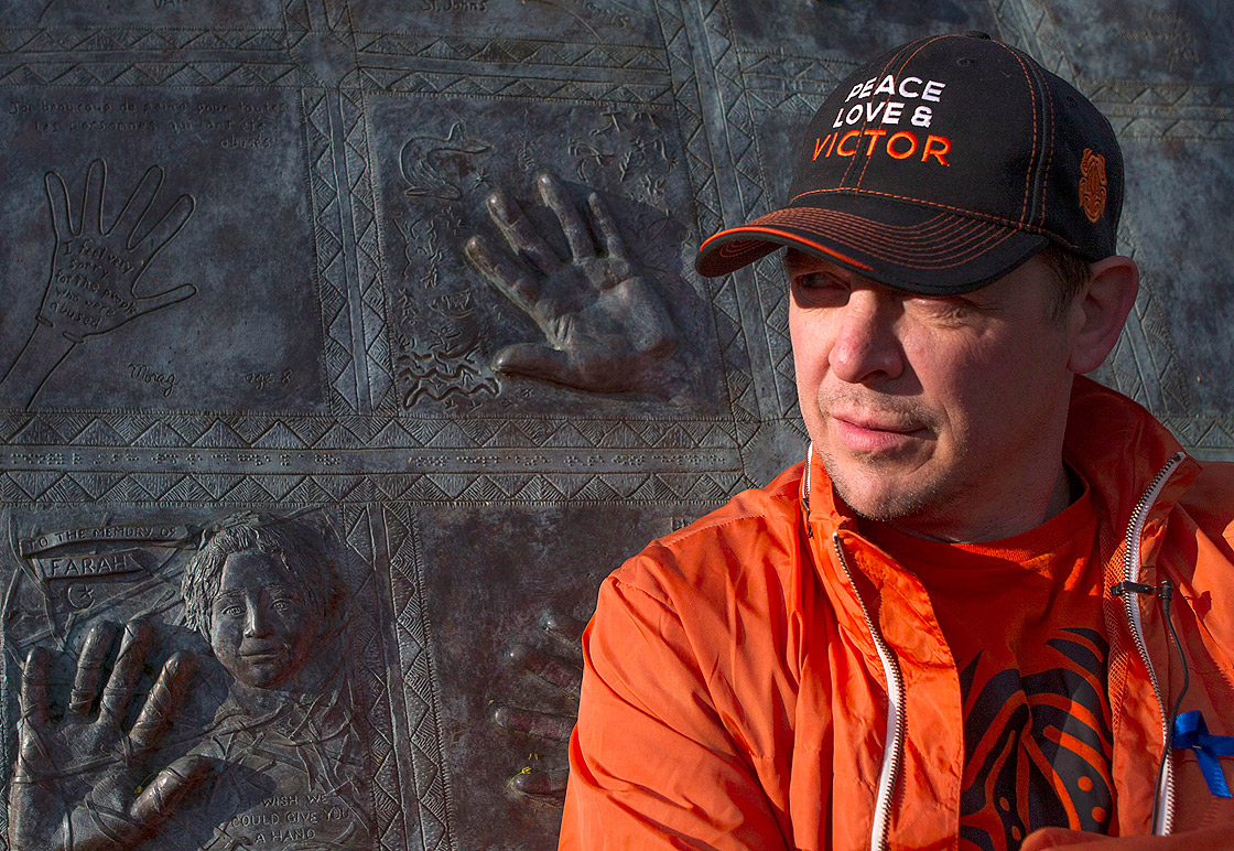 Former NHLer Theo Fleury stands in front of a child abuse monument in Toronto on May 14.