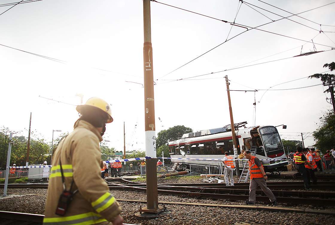 Rescuers work at the scene after after a light rail train derailed on May 17, 2013, near Hang Mei Tsuen Station at Tin Shui Wai in Hong Kong. Getty Images