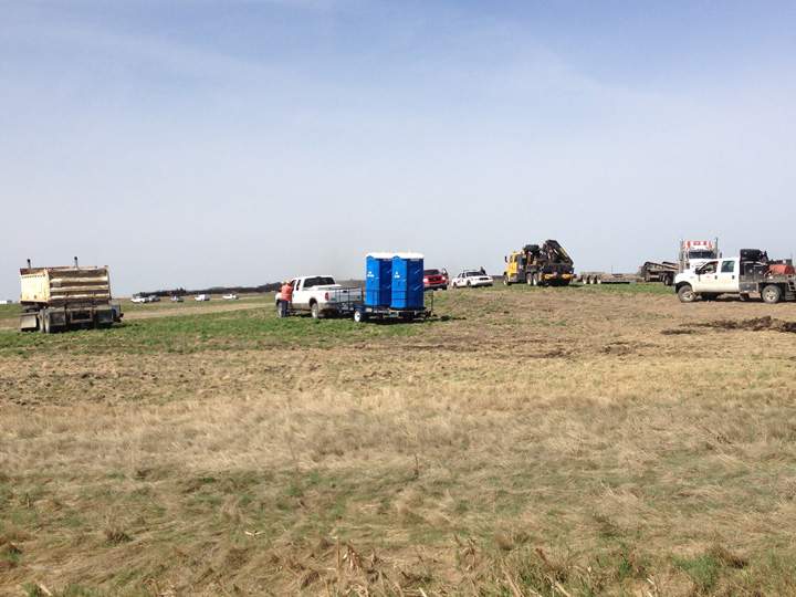 Dirt containment wall built when oil leaks after Saskatchewan train derailment.