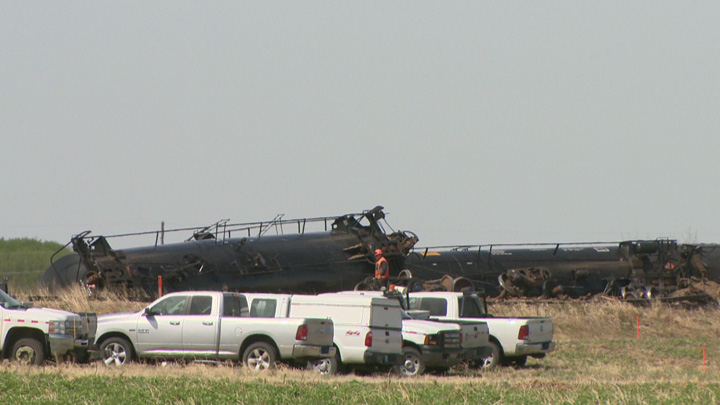 Dirt containment wall built when oil leaks after Saskatchewan train derailment.