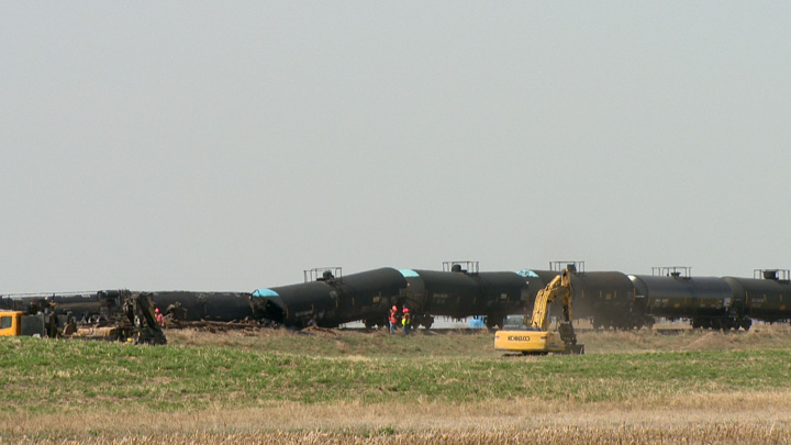 Dirt containment wall built when oil leaks after Saskatchewan train derailment.