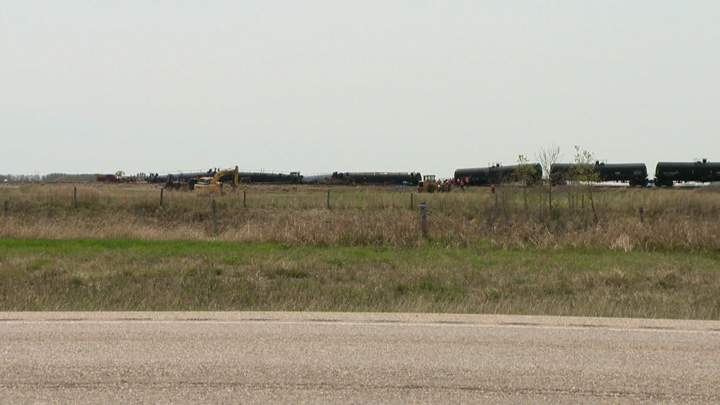 Dirt containment wall built when oil leaks after Saskatchewan train derailment.