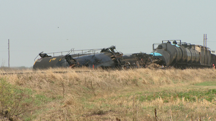 Dirt containment wall built when oil leaks after Saskatchewan train derailment.