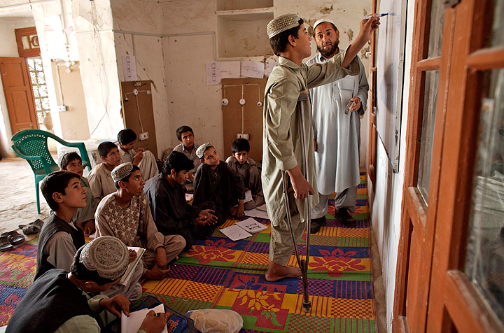 Rahmatuallah, 14, writes on a white board during a training workshop for electricians at a UNICEF-assisted reintegration and rehabilitation centre for war-affected children in the southern city of Kandahar, Afghanistan. (Photo credit: Shehzad Noorani/UNICEF)