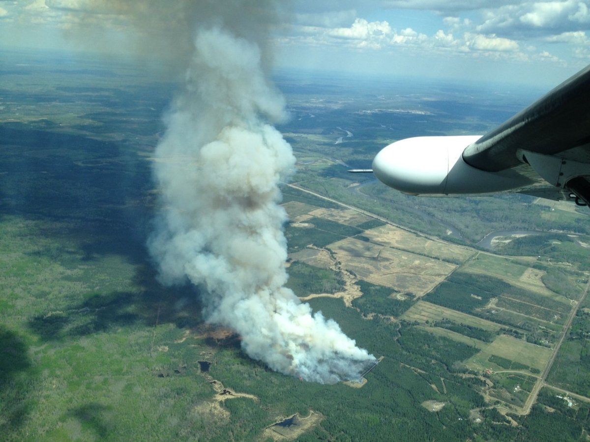 Crews battle a wildfire about eight kilometres southwest of Whitecourt, Saturday, May 18, 2013.