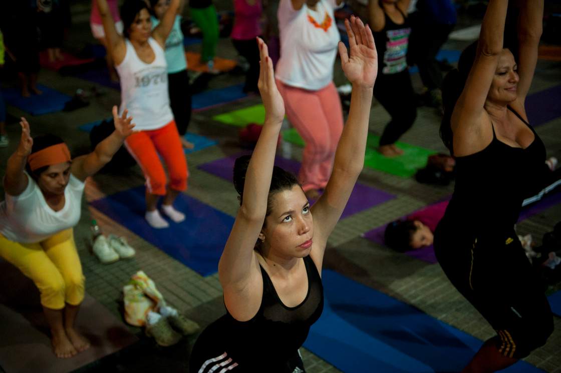 A woman does yoga in "Los Palos Grandes" public square in Caracas, on May 21, 2012. 