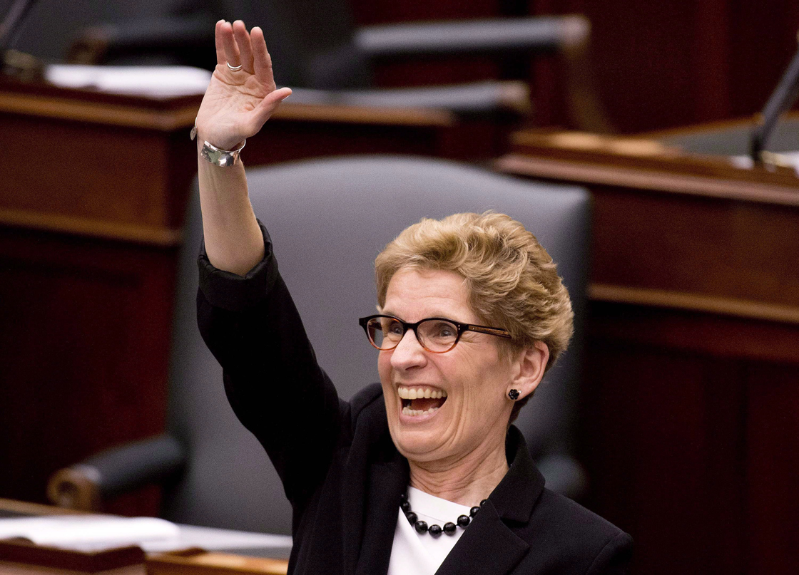 Ontario Premier Kathleen Wynne smiles a waves moments before Ontario Finance Minister Charles Sousa tables the 2013 provincial budget at Queen's Park in Toronto on Thursday, May 2, 2013. 