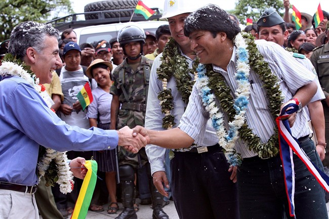 In this file photo Bolivia's President Evo Morales, right, shakes hands with U.S. ambassador Philip Goldberg during the inauguration of part of a road sponsored by the U.S. Agency for International Development (USAID) in the tropical region of El Sillar, Cochabamba, Bolivia. 