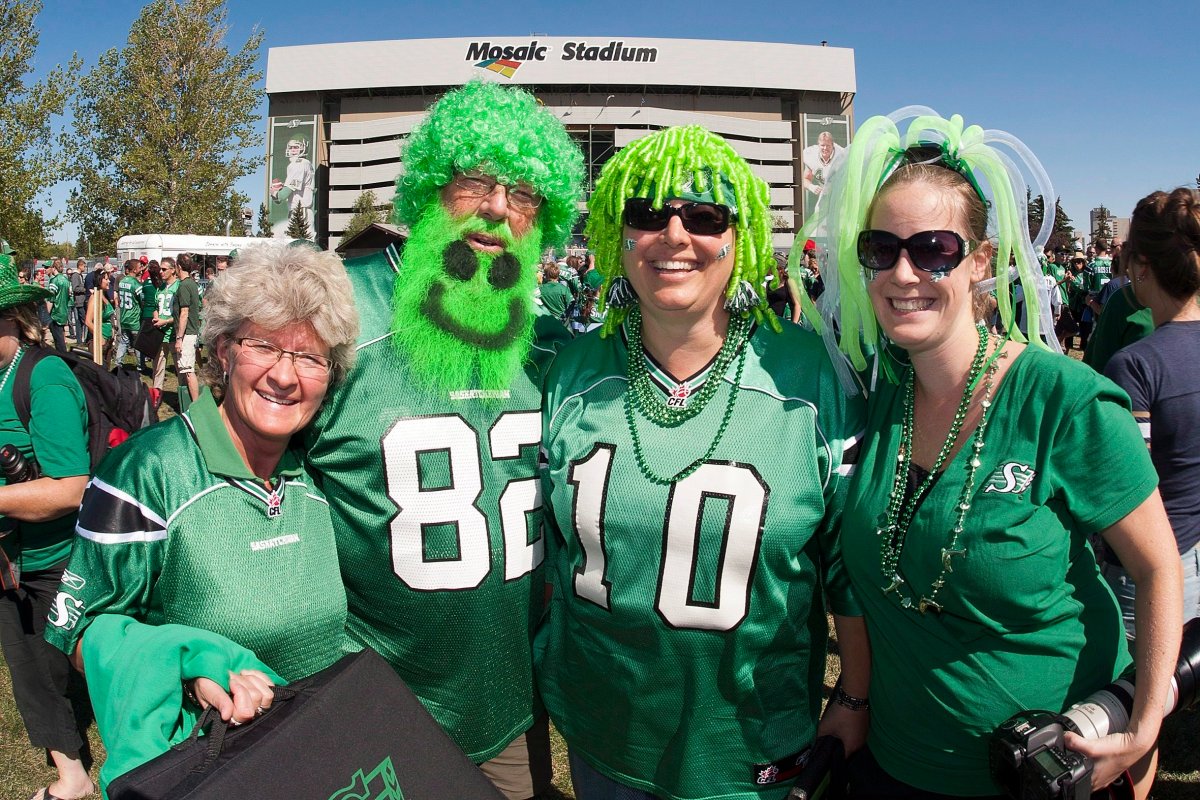 Rider fans pose for a photo before CFL football action between the Saskatchewan Roughriders and the Winnipeg Blue Bombers in Regina, Sask., Sunday, September 2, 2012. 