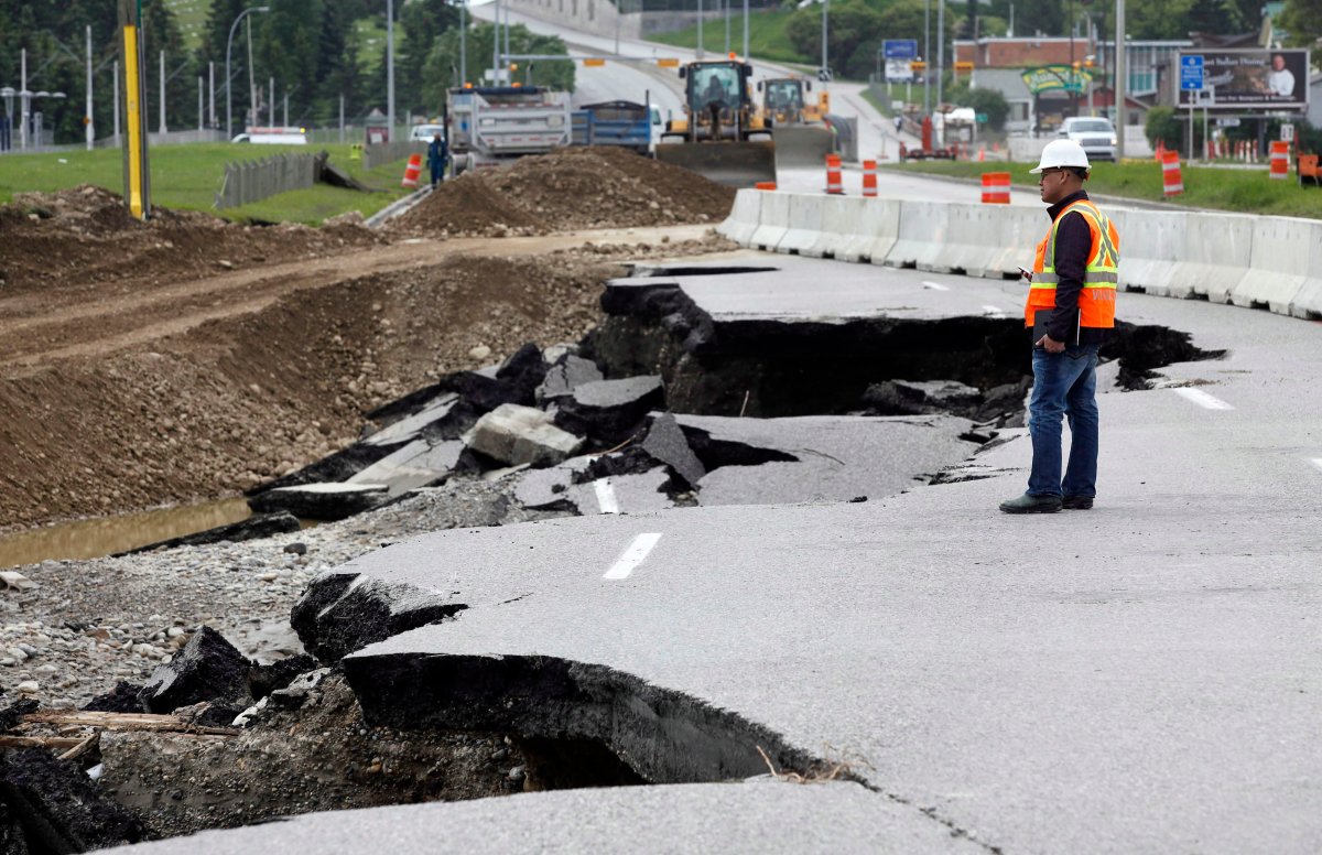 A road crew foreman surveys the washed-out lanes of northbound MacLeod Trail in Calgary, Alta., Monday, June 24, 2013. Heavy rains caused flooding, closed roads, and forced evacuations across Southern Alberta. 