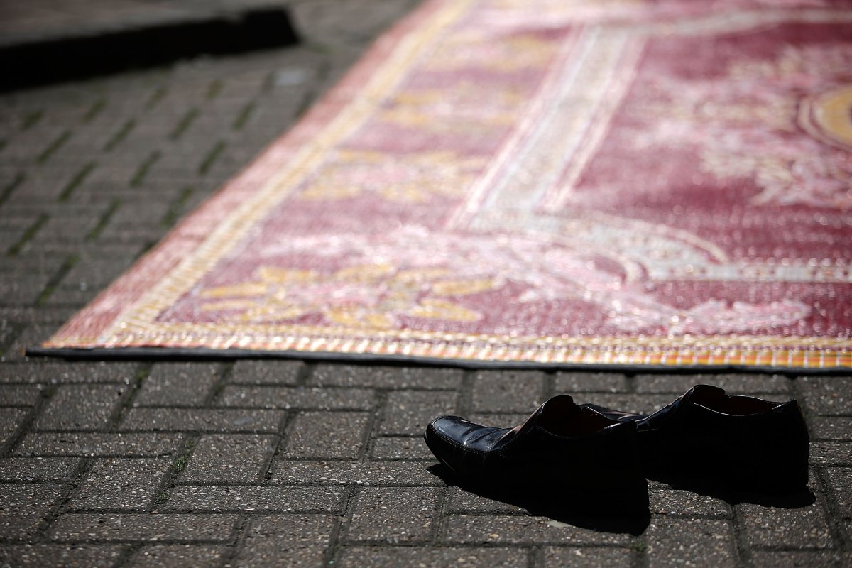 A general view of a worshippers shoes as muslims attend prayers in the sunshine at the BBC Community Centre in the Spitalfields area, close to the Square Mile, on May 31, 2013 in London, England.
