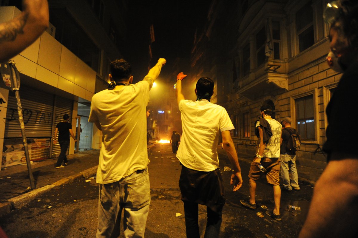 Some protesters hurled objects at withdrawing officers and police vehicles, prompting officers to fire several rounds of tear gas to push back the crowds and resumed pulling out of Taksim Square, the private Dogan news agency reported. 