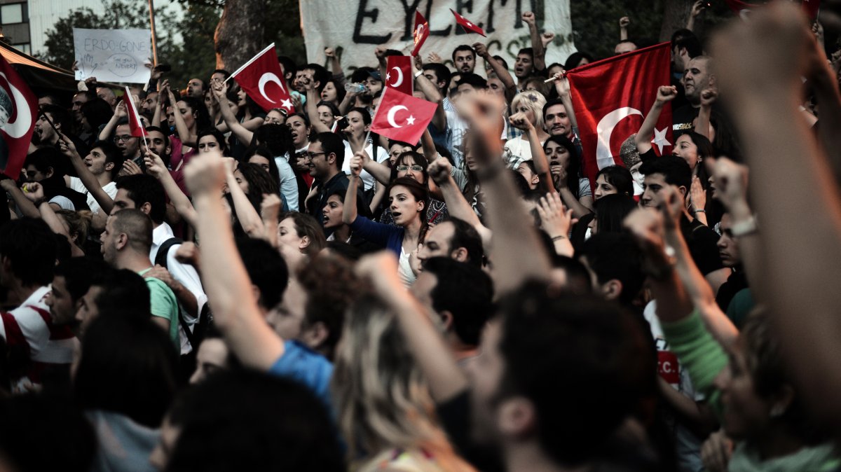 Demonstrators wave Turkish flags and shout slogans during a protest at Gazi park next to Taksim square in Istanbul on June 5, 2013.
