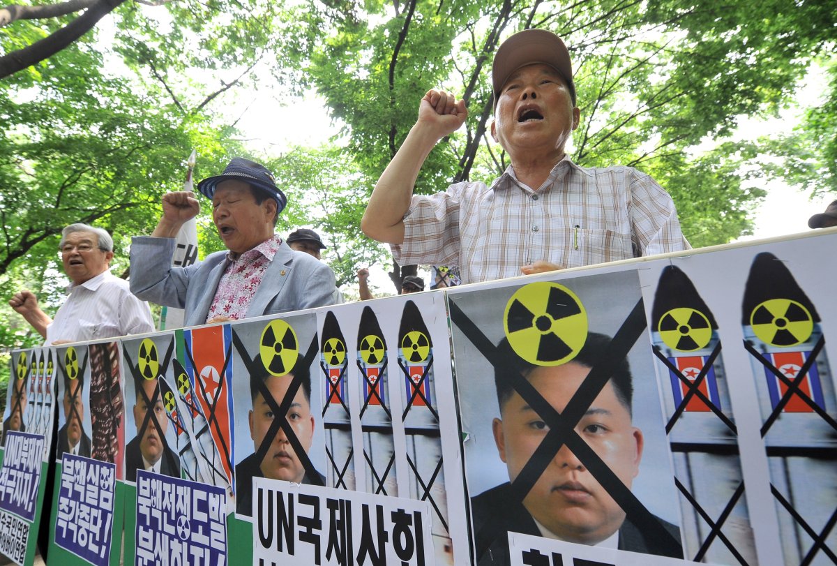 South Korean conservative activists hold placards showing portraits of North Korean leader Kim Jong-Un during an anti-Pyongyang rally to mark the 63th anniversary of the Korean War and denouncing North Korea's nuclear programs, in Seoul on June 24, 2013. North Korea has sought negotiations with the U.S. and South Korea but has ignored their demands that it first honour prior commitments to move toward nuclear disarmament. ( JUNG YEON-JE/AFP/Getty Images).