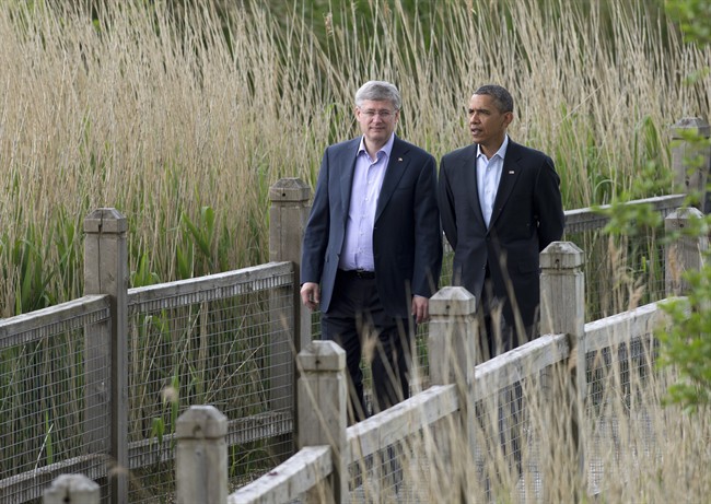 Canadian Prime Minister Stephen Harper walks with United States President Barack Obama during the G8 Summit at Lough Erne near Enniskillen, Northern Ireland, Tuesday, June 18, 2013.