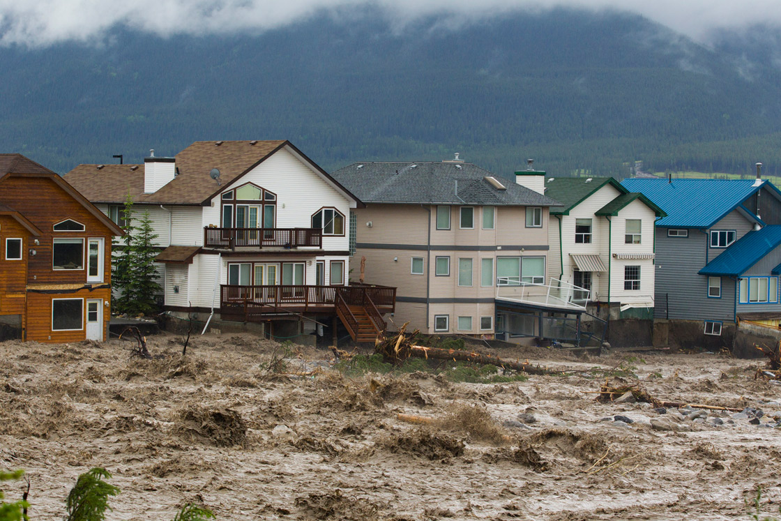 Houses damaged along the edge of Cougar Creek are shown June 20, 2013 in Canmore, Alberta, Canada. Widespread flooding caused by torrential rains washed out bridges and roads prompting the evacuation of thousands. 
