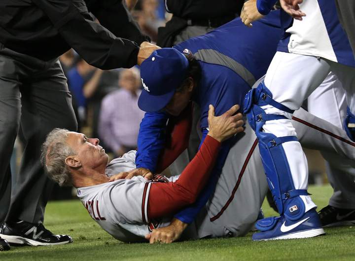 Manager Don Mattingly (R) of the Los Angeles Dodgers pushes down coach Alan Trammell #3 of the Arizona Diamondbacks during a bench clearing brawl in the seventh inning at Dodger Stadium on June 11, 2013 in Los Angeles.