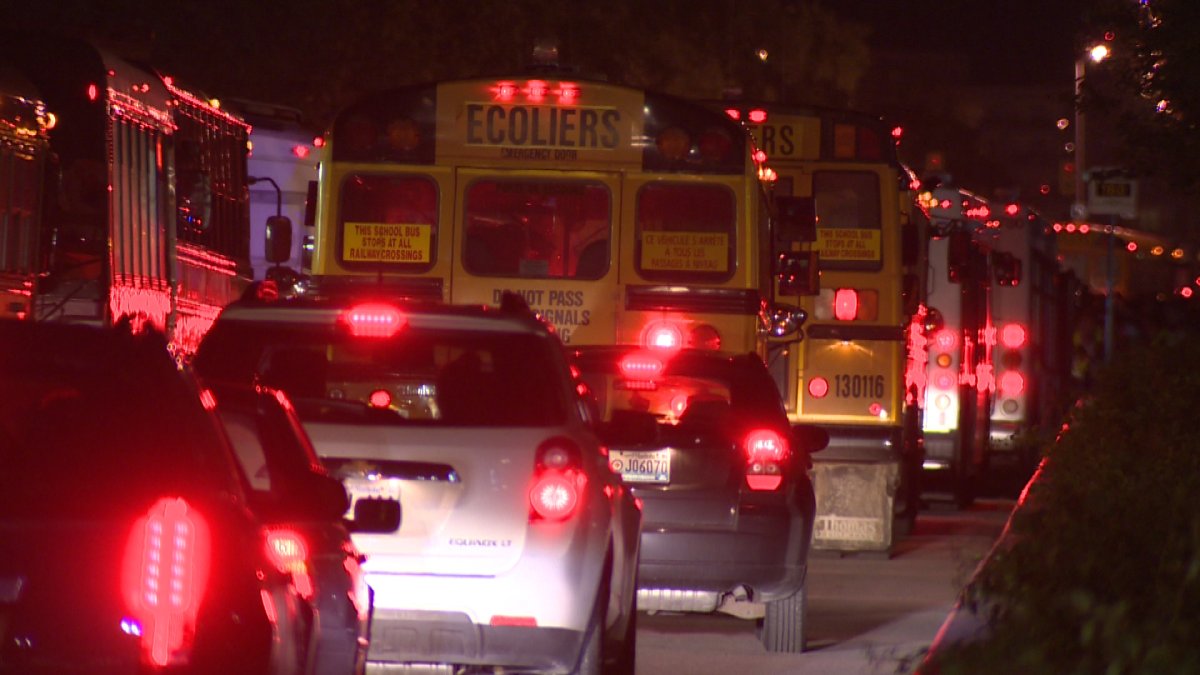 Buses and cars back up as they attempt to leave Investors Group Field on Thursday night.