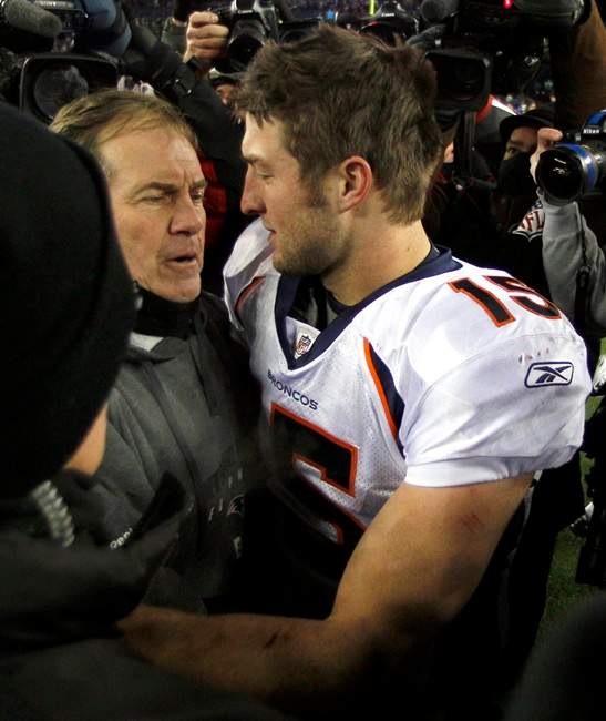FILE- In this Jan. 14, 2012, file photo, then-Denver Broncos quarterback Tim Tebow, right, hugs New England Patriots head coach Bill Belichick following an NFL divisional playoff football game in Foxborough, Mass. 
