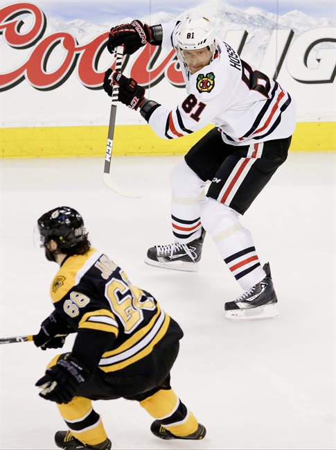 Chicago Blackhawks right wing Marian Hossa (81), of Slovakia, looks for a pass as Boston Bruins right wing Jaromir Jagr (68), of the Czech Republic defends, during the first period in Game 4 of the NHL hockey Stanley Cup Finals, Wednesday, June 19, 2013, in Boston.