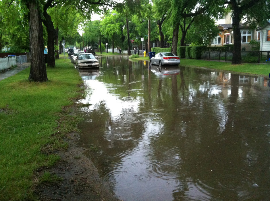 Water covers Avenue E South and 21st Street as heavy rain falls in Saskatoon.