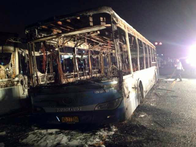 This image made with a mobile phone camera released by China's Xinhua News Agency shows the remains of an express bus that burst into flames in Xiamen, southeast China.