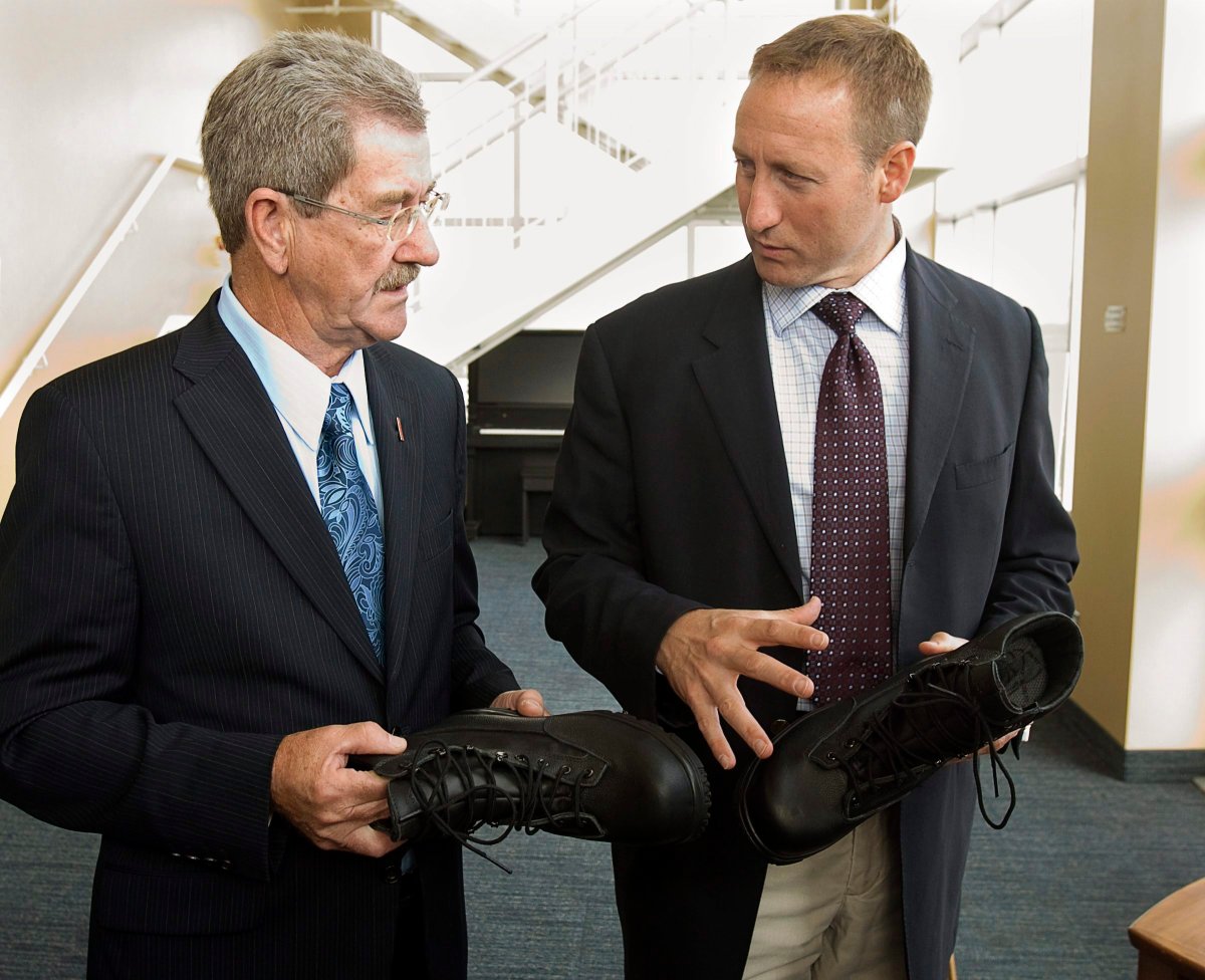 Defence Minister Peter MacKay, right, and Senator Gerald Comeau inspect new footwear for members of the Canadian navy at CFB Halifax in Halifax on Friday, Sept. 10,  2010. THE CANADIAN PRESS/Andrew Vaughan.