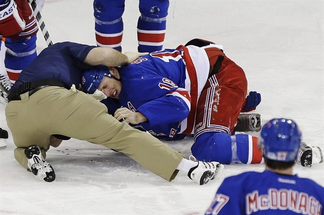 New York Rangers' Marc Staal is helped by a trainer after being injured during the third period of an NHL hockey game against the Philadelphia Flyers on March 5 in New York.