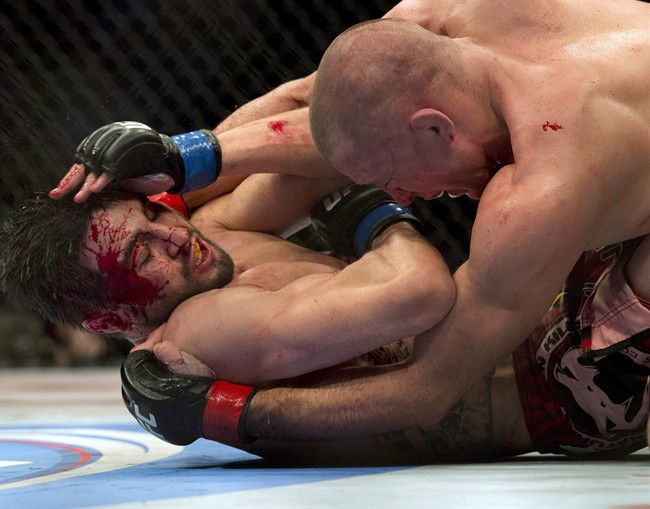 Carlos Condit, bottom, battles with Georges St-Pierre during their UFC welterweight title fight in November 2012.