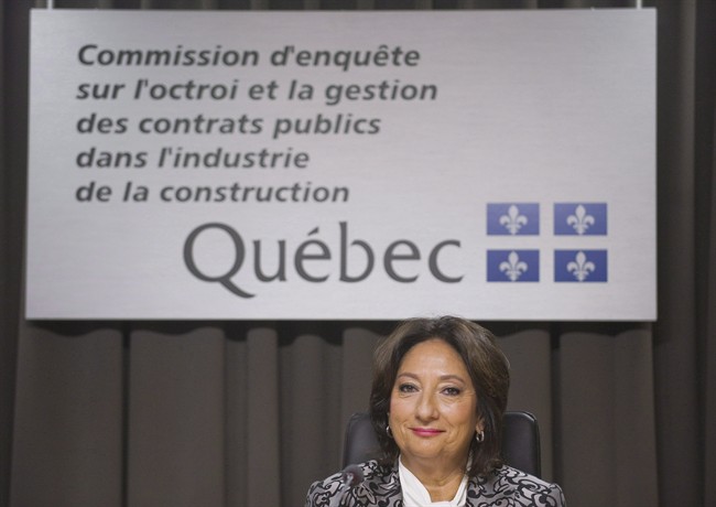 Justice France Charbonneau smiles as she sits on the opening day of a Quebec inquiry looking into allegations of corruption in the province's construction industry in Montreal, Tuesday, May 22, 2012.
