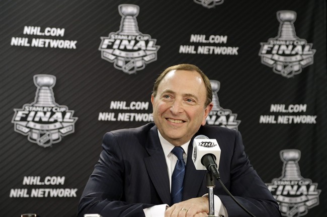 NHL Commissioner Gary Bettman smiles during a news conference.
