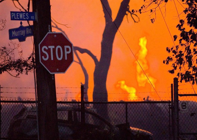 Flames shoot up at the scene of a propane explosion at Sunrise Propane in Toronto as dawn breaks on Aug. 10, 2008. 