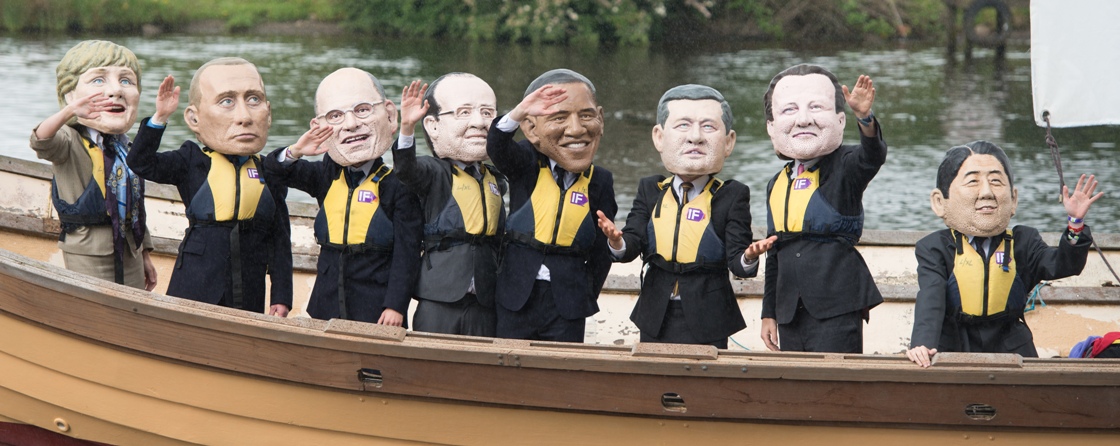 Demonstrators from the 'IF campaign' wearing masks depicting G8 leaders protest against tax avoidance during the G8 Summit.