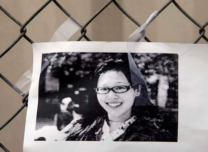 A photocopy showing Elisa Lam  of Canada is displayed at a street memorial across the Cecil Hotel in Los Angeles.
