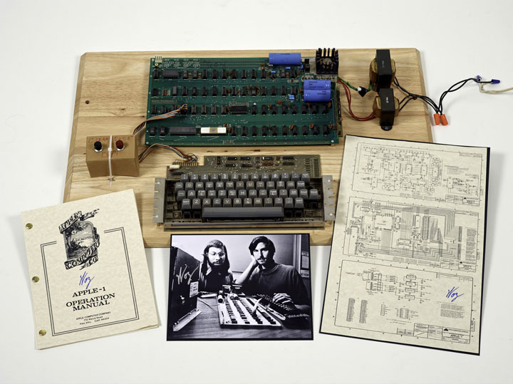 This undated photo provided by Christie’s Auction House shows an “Apple 1” prototype computer, built in 1976, accompanied by an operation manual and schematic as well as a photo of its inventors, Steve Wozniak, left, and Steve Jobs. One of the very first Apple 1 computers, it goes on sale later this month at Christie's auction house, the latest in a recent run of vintage tech sales that have attracted some eye-popping prices. 