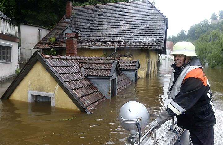 A rescuer navigates through an overflooded street in Passau, southern Germany, on June 3, 2013.