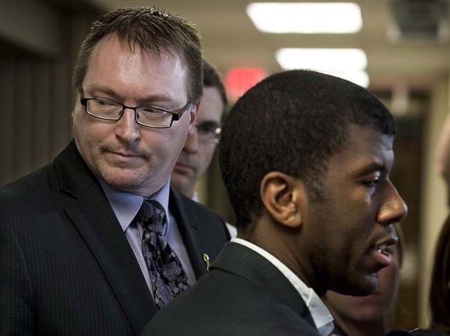 Trevor Zinck, left, accompanied by his lawyer Lyle Howe, right, talks with reporters outside Nova Scotia Supreme Court in Halifax on Monday, June 17, 2013.